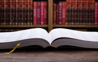 Open Law Book On Wooden Desk With Law Books